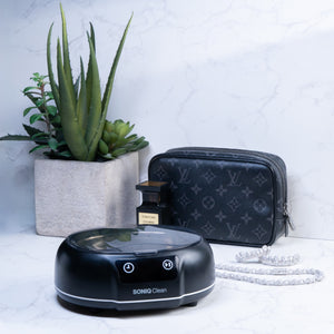 Soniq Clean ultrasonic cleaner on marble surface with jewellery and accessories
