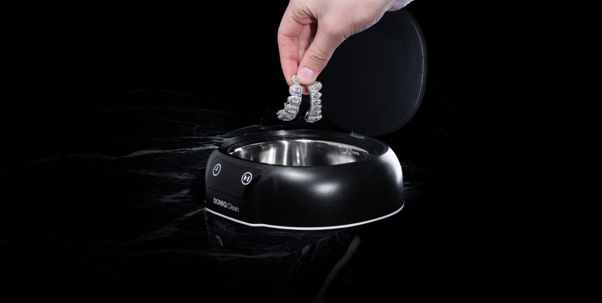 A stone-set bracelet being lowered into SONIQ Clean